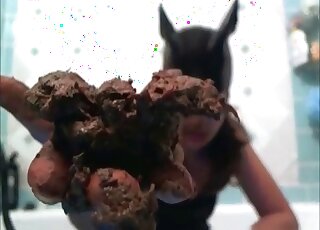 Masked woman with ripped stockings is masturbating