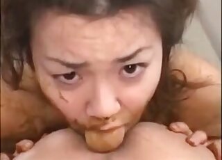 Japanese girl eating feces and giving a titjob